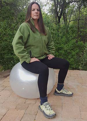 Picture of woman trainer sitting on stability ball
